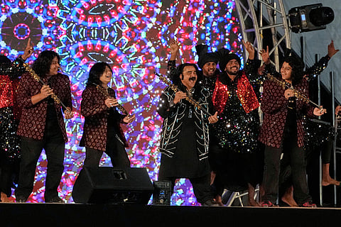 Pakistan's folk singer Arif Lohar, center, performs in a ceremony before start of the Pakistan Super League final cricket match between Peshawar Zalmi and Hyderabad Kingsmen, in Lahore, Pakistan.