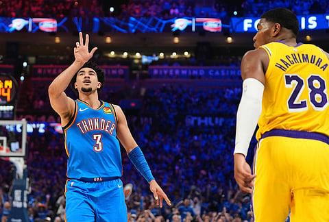 Oklahoma City Thunder guard Jared McCain (3) celebrates a three-point basket as Los Angeles Lakers' Rui Hachimura (28) jogs past in the second half of Game 1 in a second-round NBA basketball playoffs series in Oklahoma City. 
