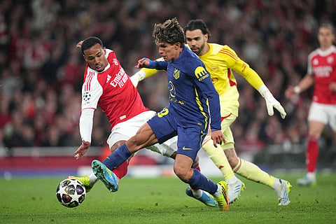 Atletico Madrid's Giuliano Simeone tries to score but falls to the ground with Arsenal's Gabriel Magalhaes, left, during a Champions League semifinal, second leg, soccer match between Arsenal FC and Atletico Madrid in London.