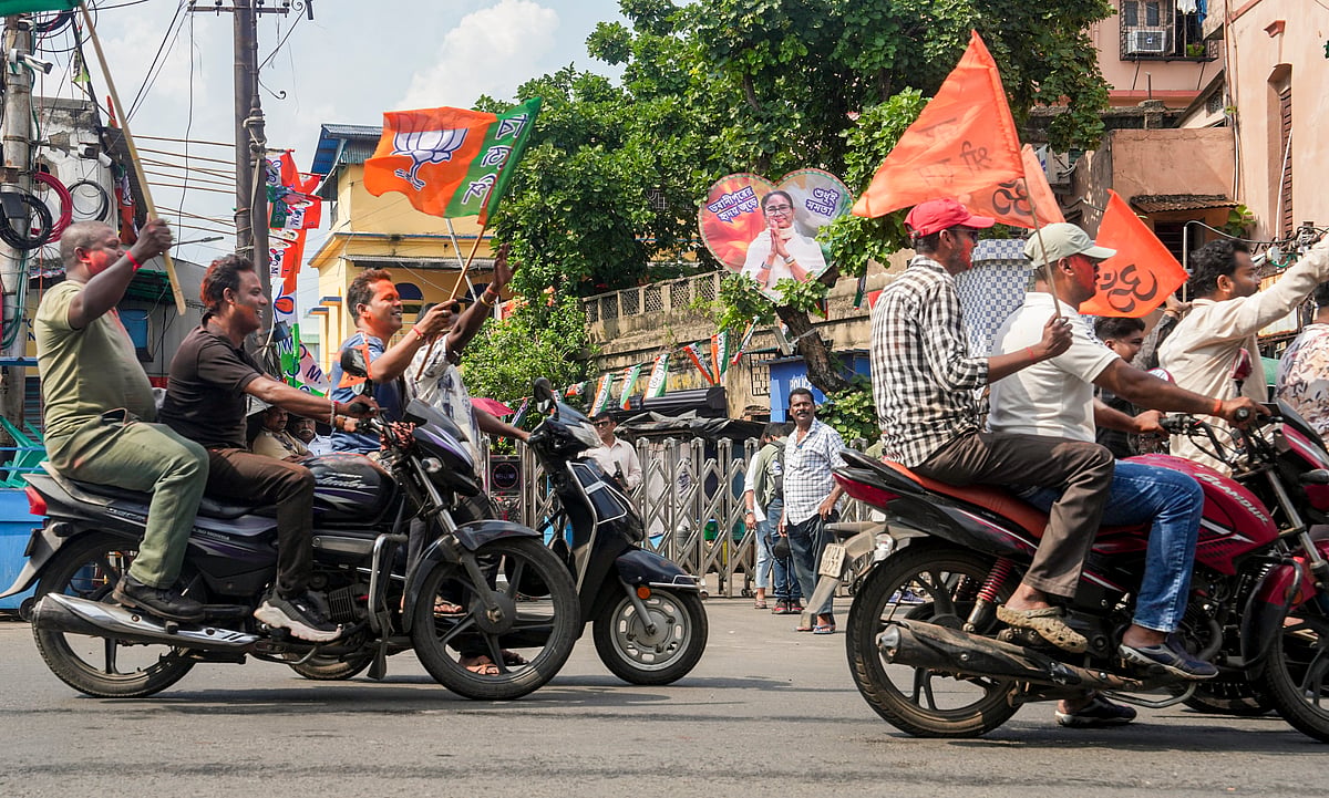 BJP supporters celebrate party's lead near the residence of West Bengal Chief Minister Mamata Banerjee during vote tabulation on the day of Assembly election results, in Kolkata. - PTI
