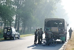 | Photo: PTI/Shiva Sharma : Security personnel remain deployed near the blast site close to the Army cantonment area at Khasa, in Amritsar district. Preliminary investigation suggested that an object was hurled towards the boundary wall, triggering the blast, police said.