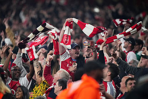 Arsenal supporters celebrate at the the end of a Champions League semifinal, second leg, soccer match between Arsenal FC and Atletico Madrid in London.