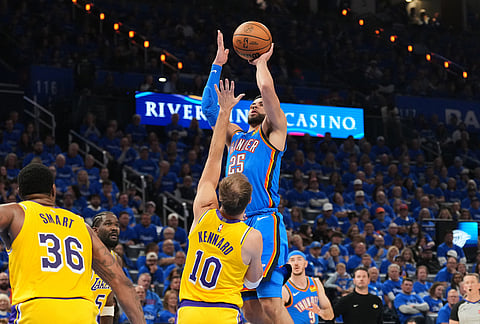 Oklahoma City Thunder guard Ajay Mitchell (25) shoots as Los Angeles Lakers' Luke Kennard (10) and Marcus Smart (36) defend in the second half of Game 1 in a second-round NBA basketball playoffs series in Oklahoma City. 
