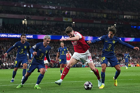 Arsenal's Viktor Gyokeres controls the ball between Atletico Madrid's Antoine Griezmann and Giuliano Simeone, right, during a Champions League semifinal, second leg, soccer match between Arsenal FC and Atletico Madrid in London.