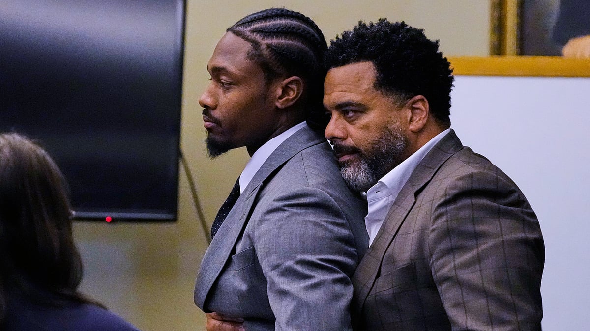 Former New England Patriots wide receiver Stefon Diggs, left, is embraced after a not guilty verdict at his trial at Norfolk County District Court, Tuesday, May 5, 2026, in Dedham, Mass. - (AP Photo/Charles Krupa, Pool)
