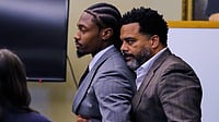 (AP Photo/Charles Krupa, Pool) : Former New England Patriots wide receiver Stefon Diggs, left, is embraced after a not guilty verdict at his trial at Norfolk County District Court, Tuesday, May 5, 2026, in Dedham, Mass.