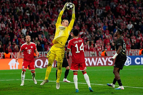 PSG's goalkeeper Matvey Safonov saves the ball during the Champions League semifinal second leg soccer match between Bayern Munich and Paris Saint Germain in Munich, Germany.