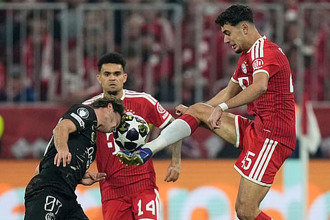 Bayern's Aleksandar Pavlovic, right, challenges PSG's Joao Neves during the Champions League semifinal second leg soccer match between Bayern Munich and Paris Saint Germain in Munich, Germany.