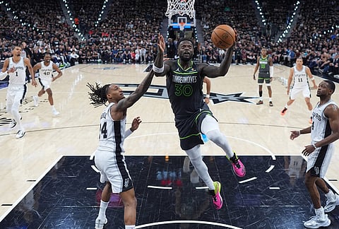 Minnesota Timberwolves forward Julius Randle (30) drives to the basket against San Antonio Spurs guard Devin Vassell (24) during the first half in Game 2 of a second-round NBA playoffs basketball series in San Antonio.
