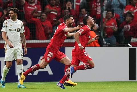 Everardo Lopez of Mexico's Toluca, right, celebrates scoring his side's 2nd goal against of the United States' Los Angeles FC during a CONCACAF Champions Cup second leg semifinal soccer match in Toluca, Mexico.