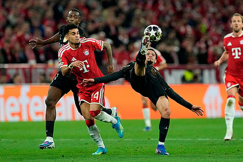 PSG’s Warren Zaire-Emery, right, kicks the ball as Bayern's Luis Diaz looks on during the Champions League semifinal second leg soccer match between Bayern Munich and Paris Saint Germain in Munich, Germany.