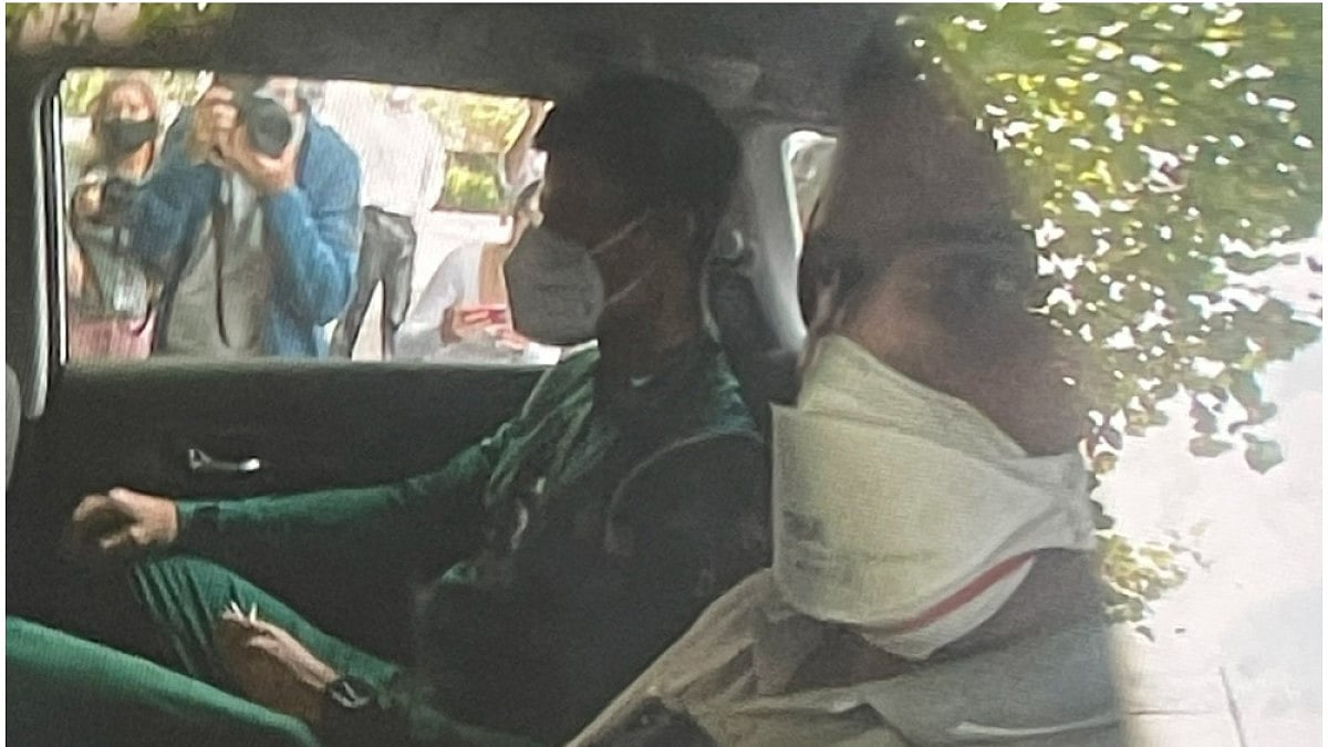 Novak Djokovic sits in the back of car arriving at an immigration detention hotel in Melbourne.