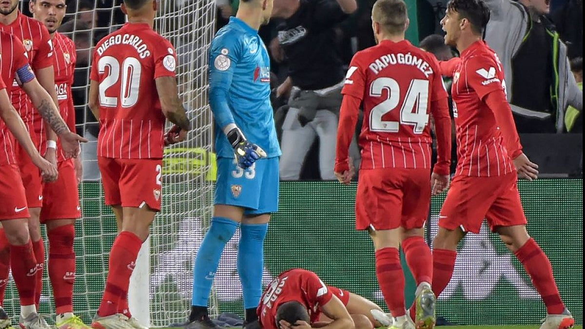 Sevilla's central midfielder Joan Jordan on floor after getting hit by a PVC rod.