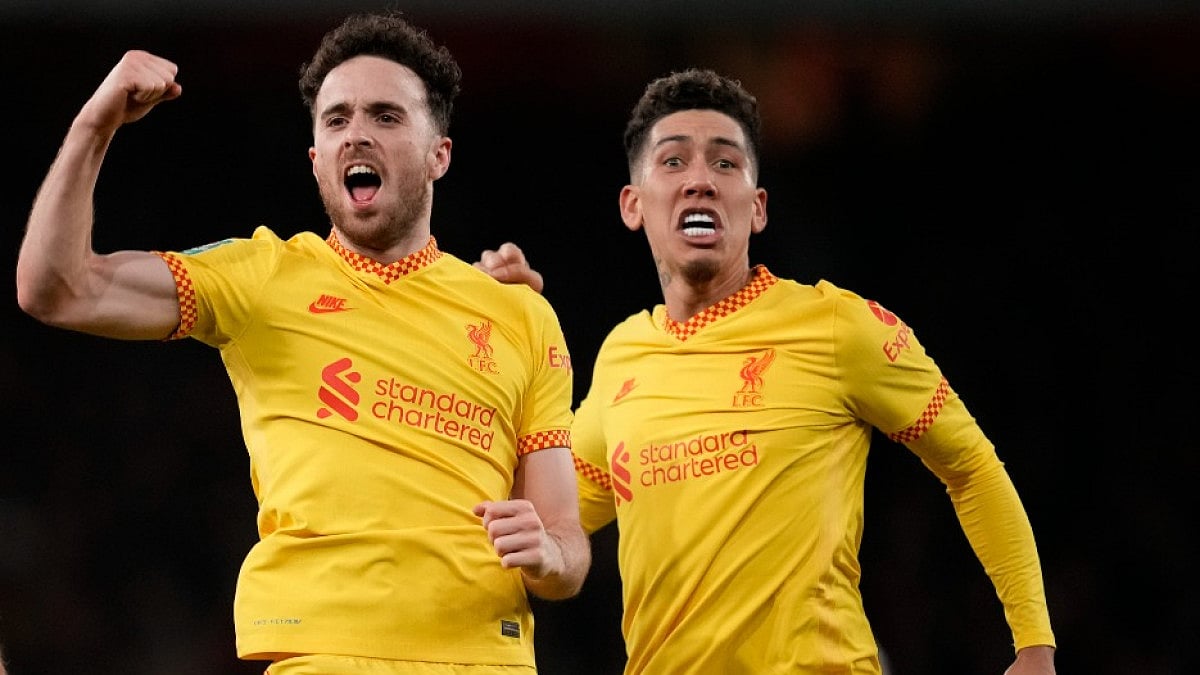 Liverpool's Diogo Jota (L) celebrates with Roberto Firmino after scoring against Arsenal.