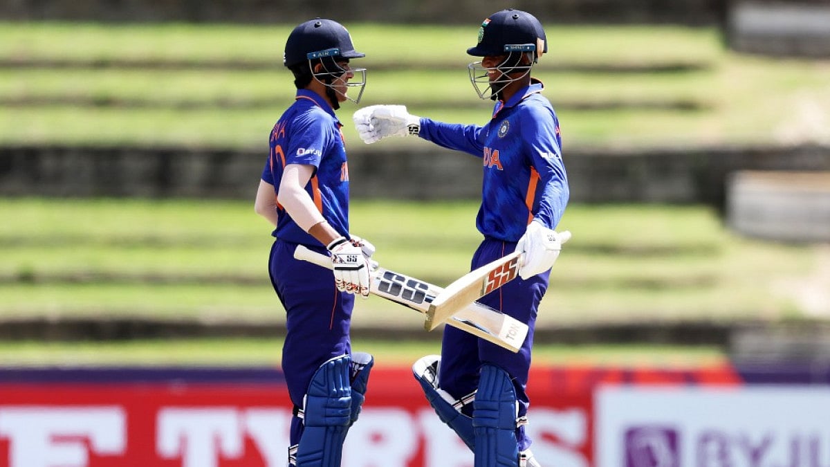 Raj Bawa (L) celebrates his century with Angkrish Raghuvanshi against Uganda on Saturday.
