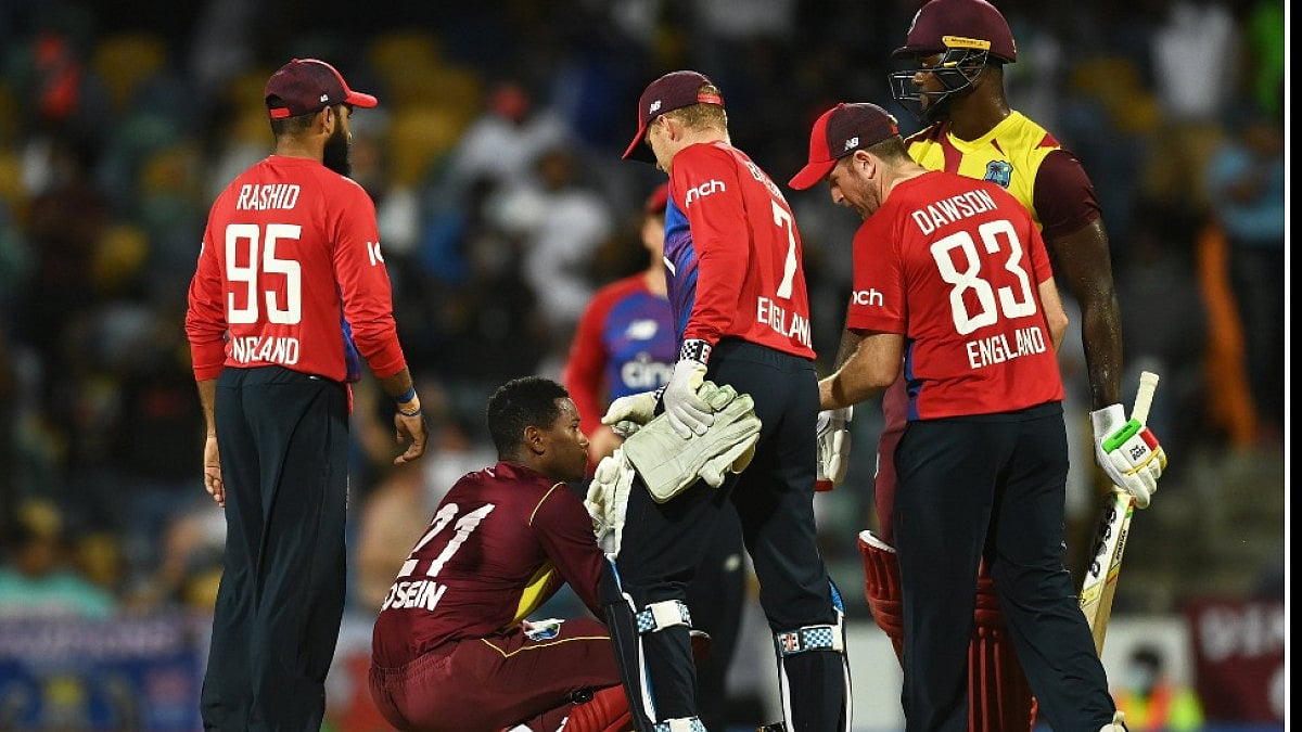 Akeal Hosein is consoled by England players after West Indies lost the second T20I by a run.