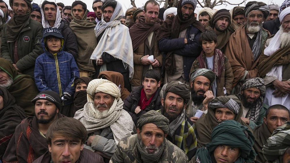 Afghan men gather to apply for the humanitarian aid in Qala-e-Naw, Afghanistan.