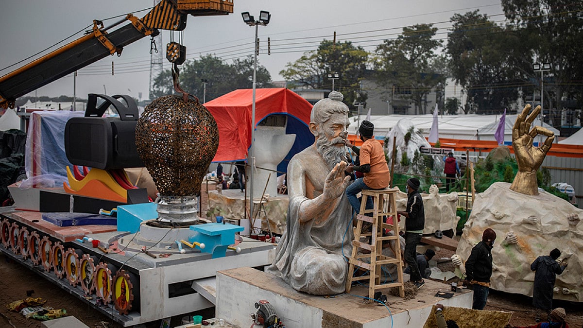 Workers give final touches to a tableau during a press preview of the upcoming Republic Day parade.