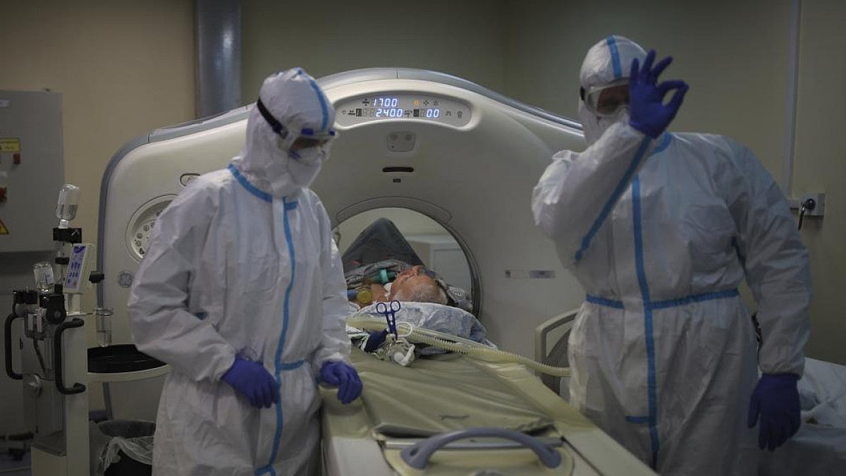 Medical staff transfers a Covid-19 patient at an ICU in Russian hospital.