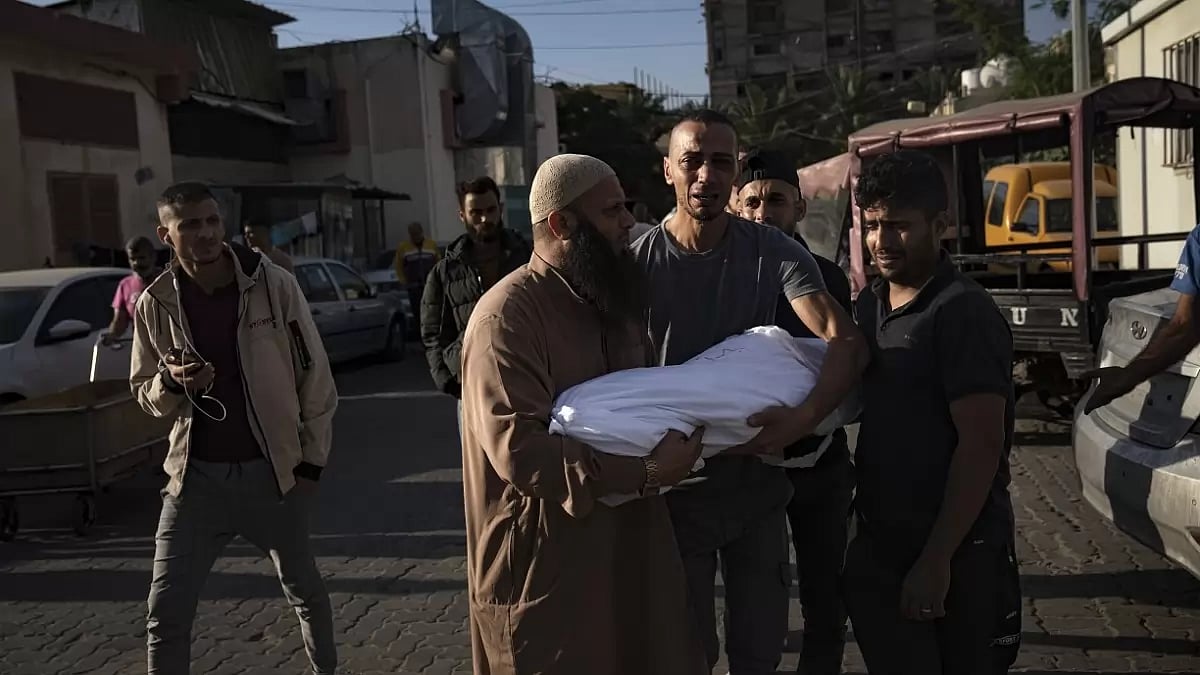 A Palestinian carries a child killed in the Israeli bombardment of the Gaza Strip.