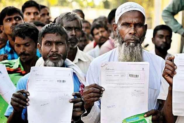File Photo : Indians Hold Up Their Identity Papers 