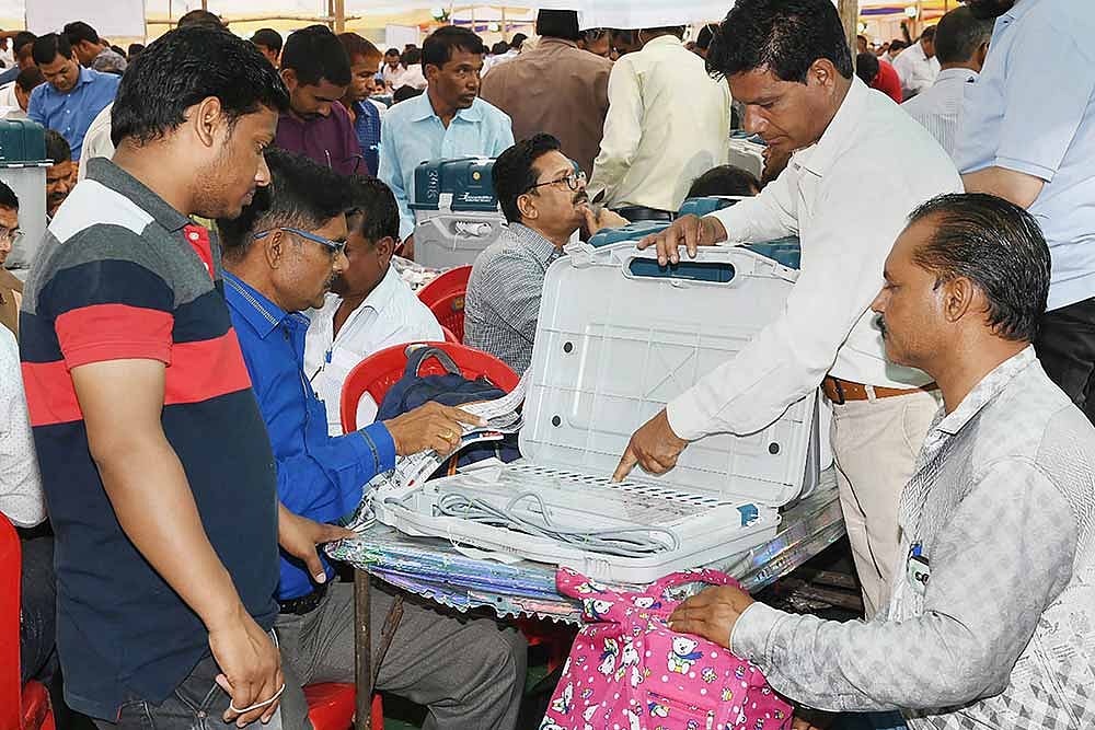 Polling officials check Electronic Voting Machine (EVM)s and other necessary inputs required for the general elections, ahead of the seventh and last phase of Lok Sabha polls, at a distribution centre, in Indore. (Representative Photo)
