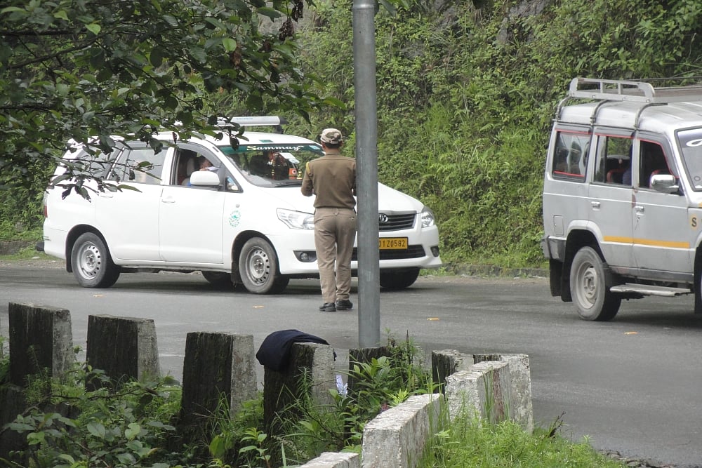 A police constable collecting permits from cab drivers of tourtists en route to Tsomgo Lake and Baba Harbhajan Singh Temple in Sikkim
