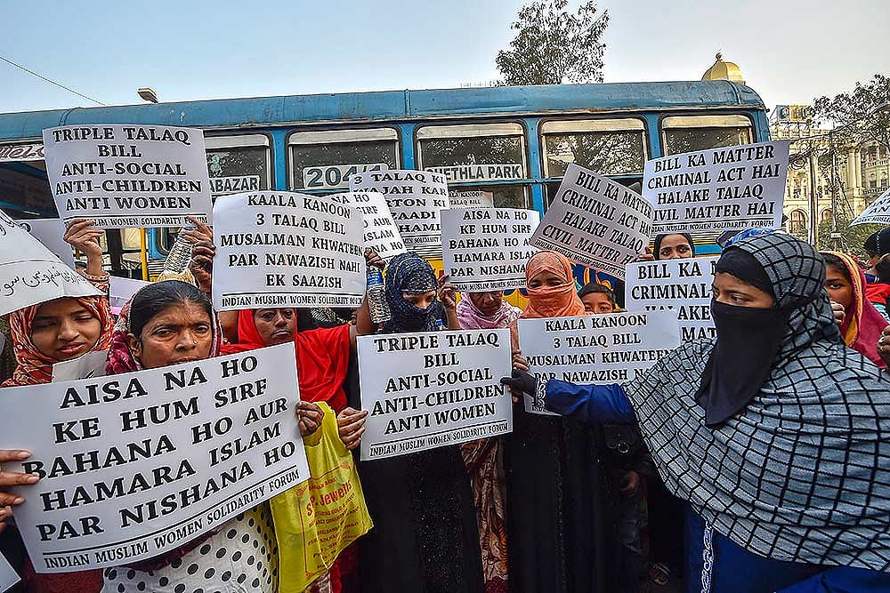 Members of Indian Muslim Women Solidarity Forum hold placards during a protest against Triple Talaq Bill, in Kolkata.