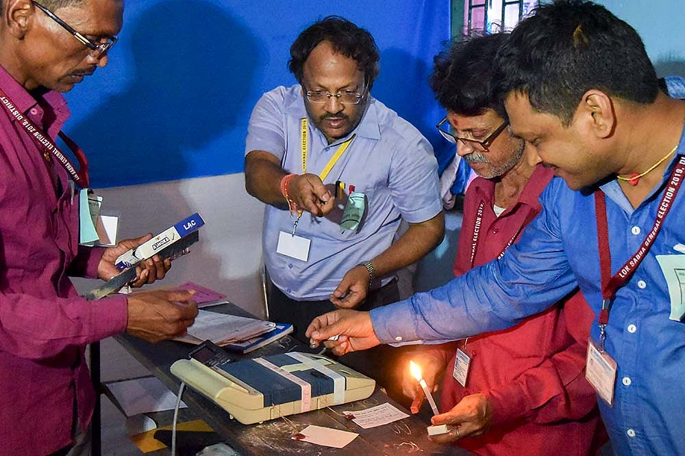 In this file photo, polling officials seal the Electronic Voting Machines (EVM)s after conclusion of the seventh and last phase of Lok Sabha elections, in Patna. (PTI)