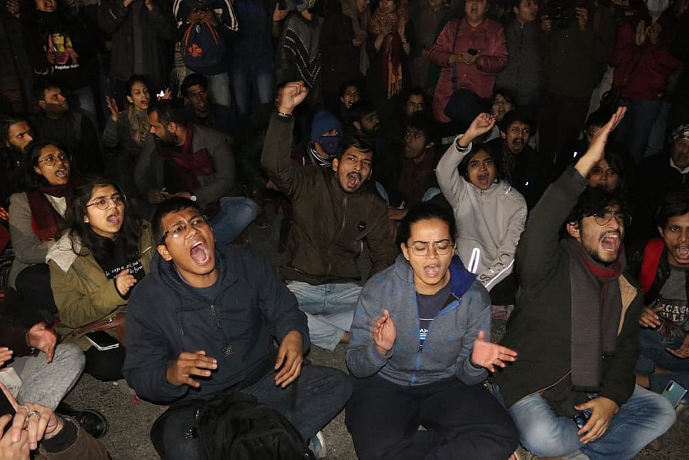 Students protest after a mob comprising masked men and women attacked students and teachers on JNU campus. 