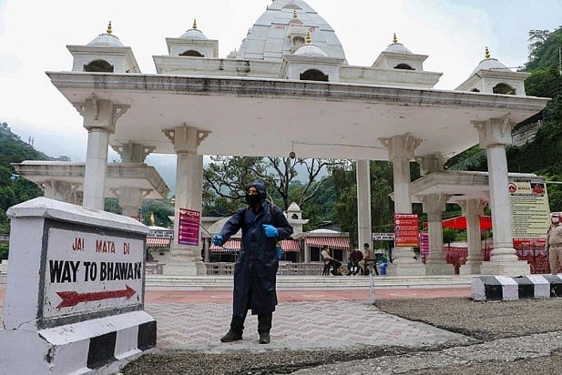 A worker sprays disinfectants at Vaishno Devi temple 