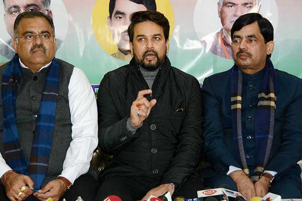 Union Minister of State for Finance and Corporate Affairs Anurag Thakur (C) along with BJP National General Seretary Tarun Chugh (L) and party National Spokesman Syed Shahnawaz Hussain (R) addresses a press conference, in Srinagar.