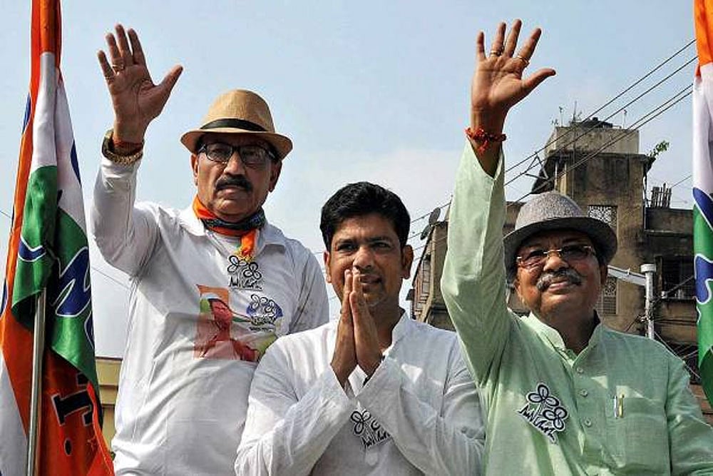 FILE - Veteran footballer and Trinamool Congress candidate Prasun Banerjee with West Bengal ministers Laxmi Ratan Shukla (C) and Arup Roy (R) campaigns for the upcoming Lok Sabha elections, in Howrah.