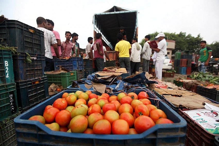 Labourers carry tomatoes at Delhi’s Ghazipur market. 