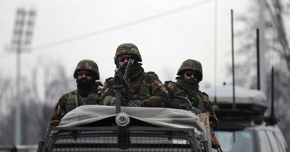 Indian army soldiers guard on top of their armored vehicle 