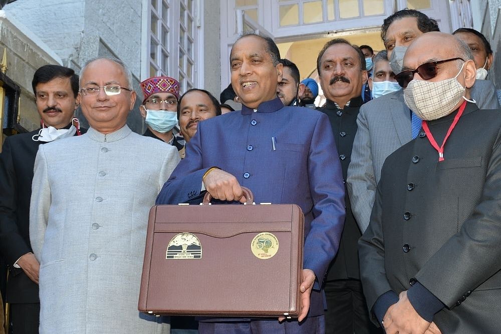 Chief Minister Jai Ram Thakur with Chief Secretary Anil Khachi and team of officers from the Finance department with suitcase of Budget .