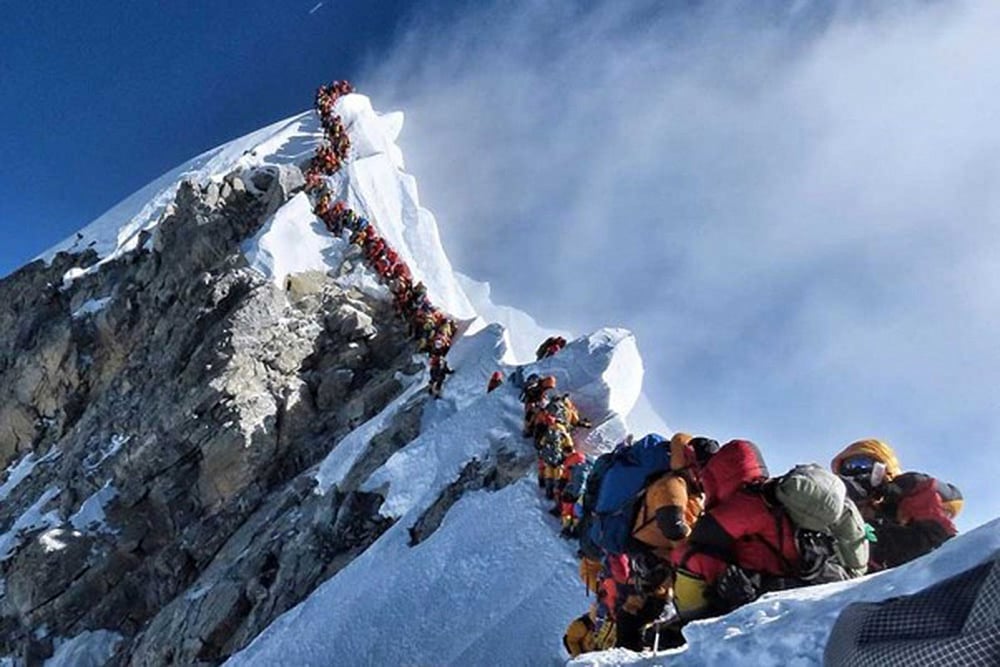 File Photo: A long queue of mountain climbers line a path on Mount Everest.