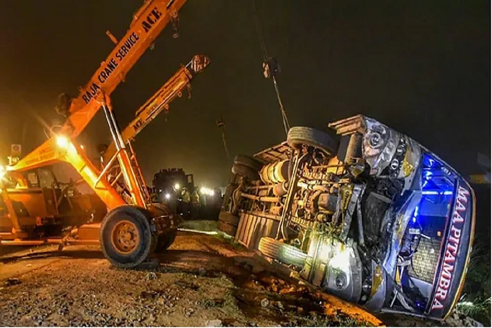 A crane lifts the bus overturned in an accident on Kanpur-Allahabad highway