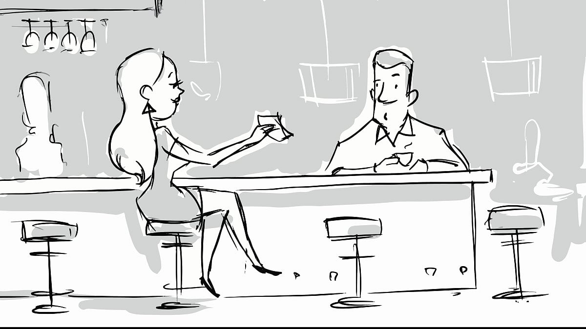 A woman goes to drink at a bar