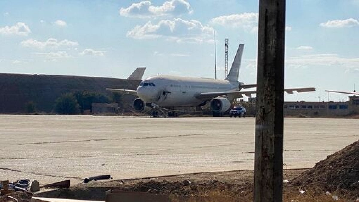 A damaged aircraft sits on the tarmac of Baghdad airport, after it was attacked