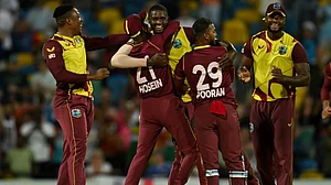 West Indies players congratulate Jason Holder (C) after their win against England in fifth T20I.