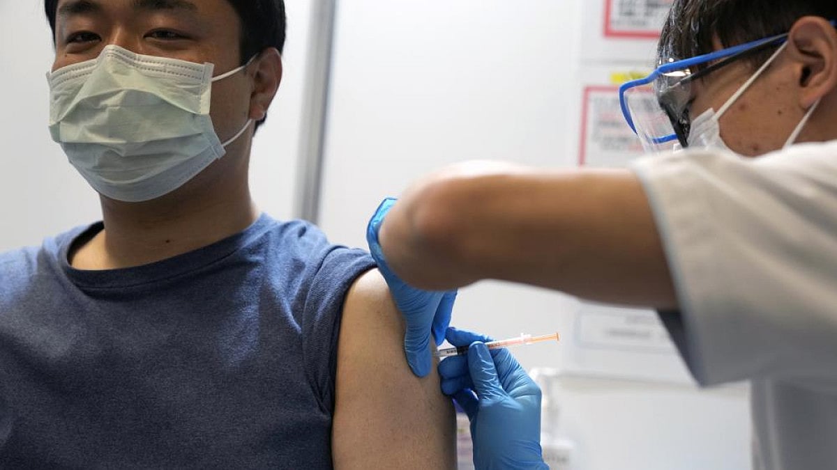 A local in Japan receives the booster shot of the Moderna coronavirus vaccine at a mass vaccination 
