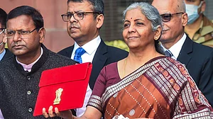 Nirmala Sitharaman holds a folder-case containing Budget 2022-23 as leaves from the Finance Ministry