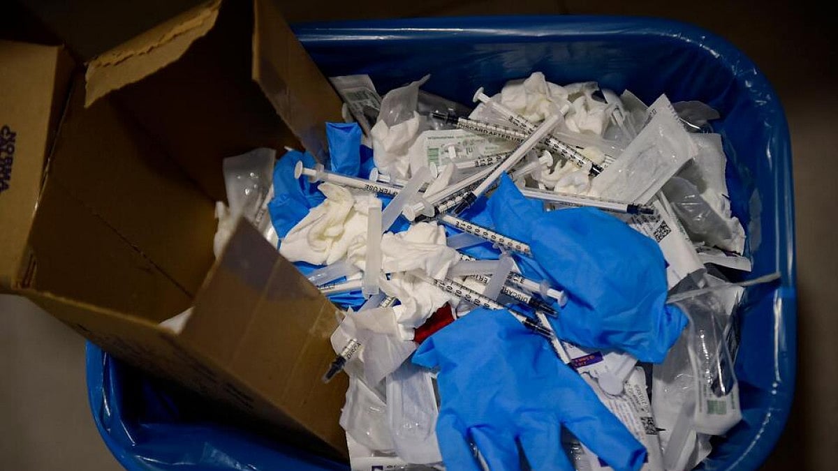  A waste basket with syringes and gloves in Spain. 