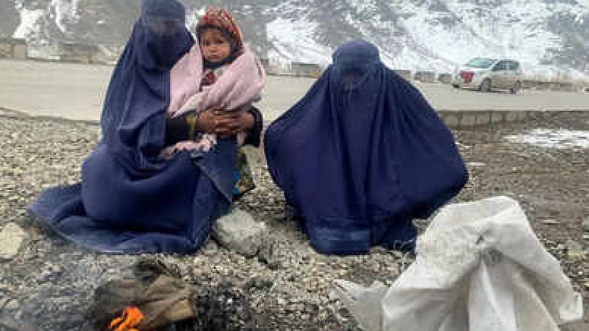 Gulnaz has to keep her 18-month-old son warm as she begs on a bitterly cold highway on the road to Kabul