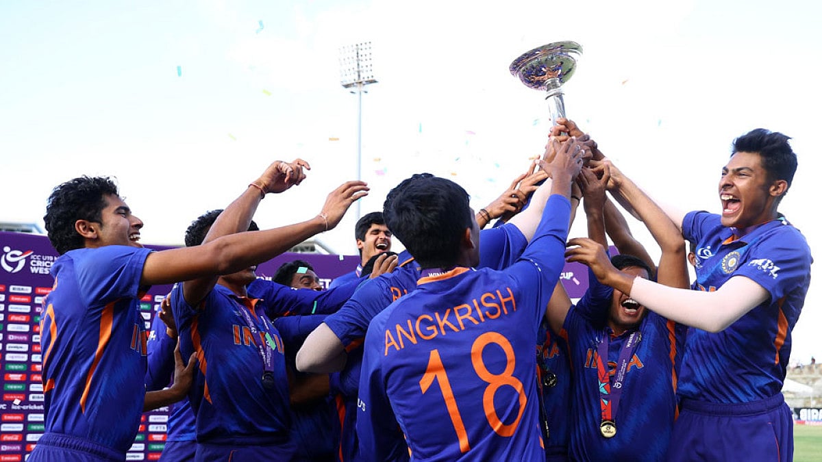 Indian cricketers lift the ICC T20 U-19 World Cup trophy after beating England in 2022 final.