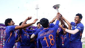 Indian cricketers lift the ICC T20 U-19 World Cup trophy after beating England in 2022 final.