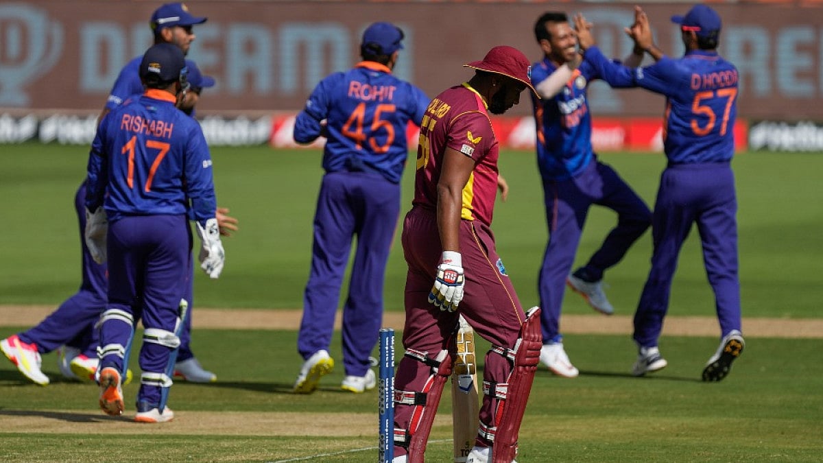 West Indies captain Kieron Pollard walks back after being clean bowled by India's Yuzvendra Chahal.