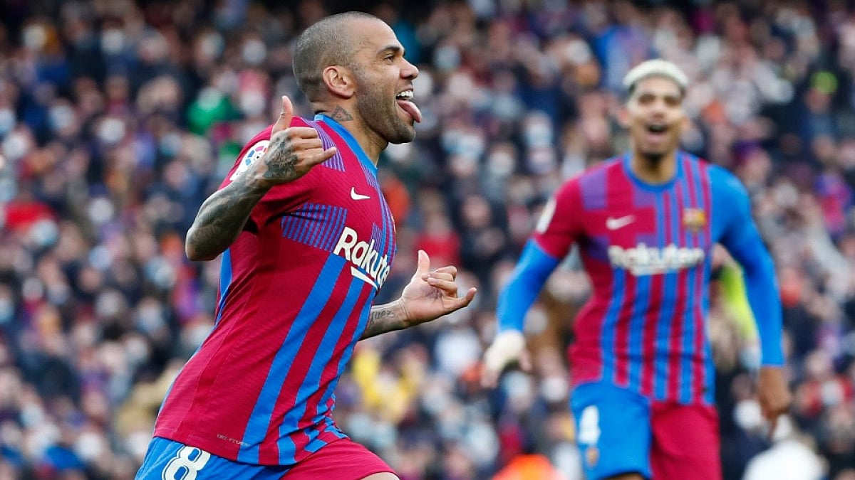 Dani Alves (L) was taken into custody after he answered a police summons while in Spain.