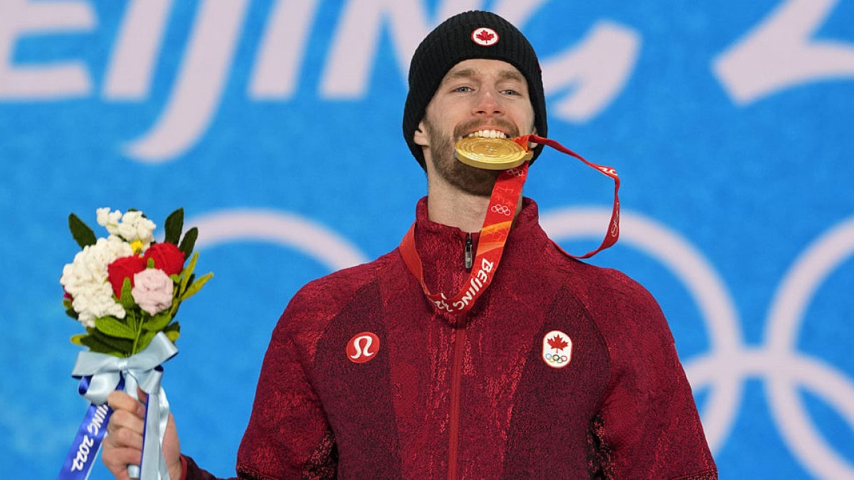 Snowboard slopestyle gold medalist Canada's Max Parrot celebrates during a medal ceremony.
